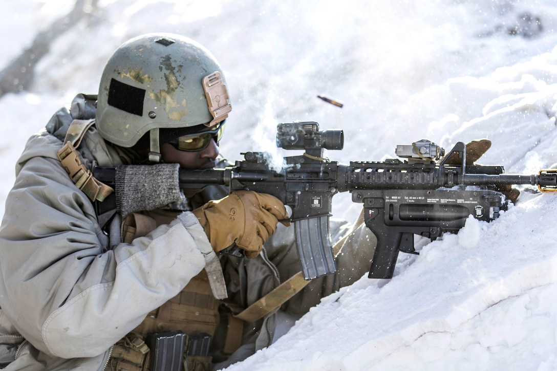 A soldier fires blank rounds at opposing forces.