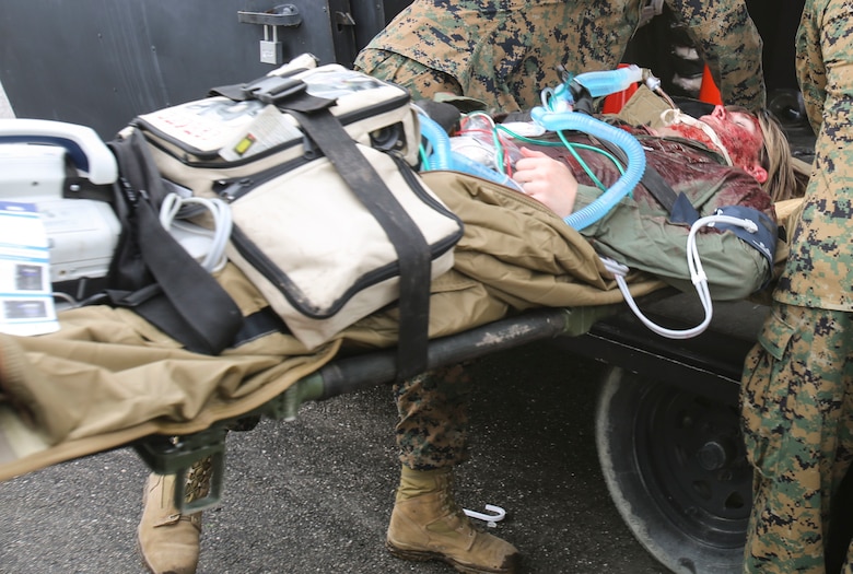 A U.S. service member is loaded onto an aircraft after being stabilized by Navy doctors and hospital corpsmen with 2nd Medical Battalion, 2nd Marine Logistics Group, during a certification exercise at Camp Lejeune, N.C., March 1, 2018. The exercise was designed for shock trauma platoons and forward resuscitation surgical units to ensure the unit sustains medical proficiency and is capable of handling emergencies in future deployments.