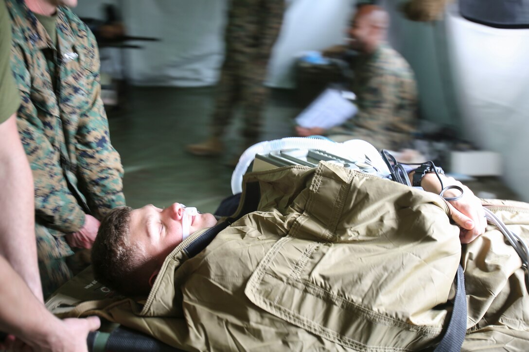 U.S. Navy doctors and hospital corpsmen simulate transporting a wounded service member for a medical evacuation after being stabilized by doctors and hospital corpsmen with 2nd Medical Battalion, 2nd Marine Logistics Group, during a certification exercise at Camp Lejeune, N.C., March 1, 2018. The exercise was designed for shock trauma platoons and forward resuscitation surgical units to ensure the unit sustains medical proficiency and is capable of handling emergencies in future deployments.