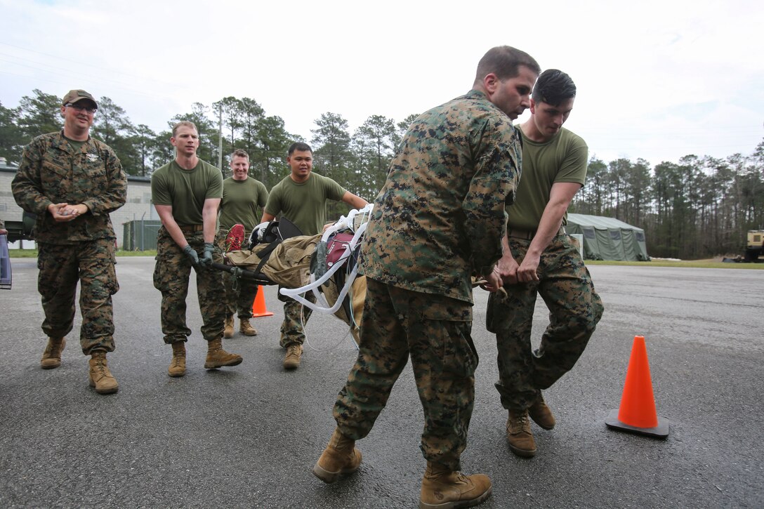 U.S. Navy doctors and hospital corpsmen with 2nd Medical Battalion, 2nd Marine Logistics Group, simulate loading a wounded service member onto an aircraft for a medical evacuation during a certification exercise at Camp Lejeune, N.C., March 1, 2018.  The exercise was designed for shock trauma platoons and forward resuscitation surgical units to ensure the unit sustains medical proficiency and is capable of handling emergencies in future deployments.