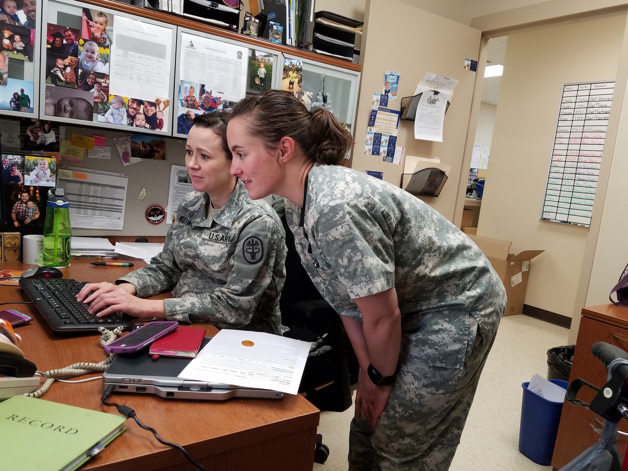 Dr. Cassandra Kerwin (seated) and Dr. Jessica Clarkson reviewing some information for upcoming appointments. (U.S. Air Force photo/Laura McGowan)