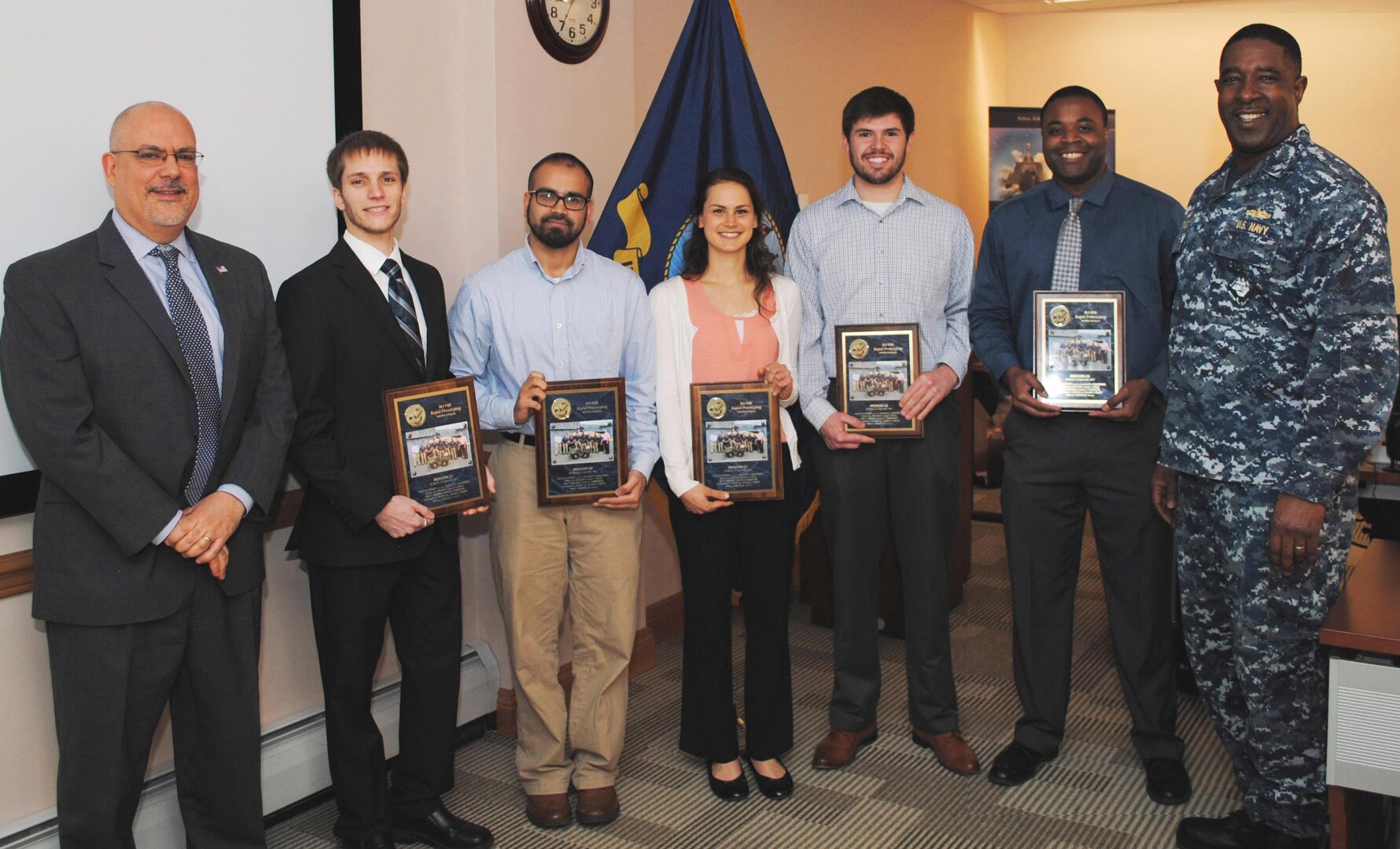 IMAGE: DAHLGREN, Va. (Feb. 26, 2018) - Five members of the Naval Surface Warfare Center Dahlgren Division (NSWCDD) Sly Fox Mission 22 team - Michael Parkison, Jamshaid Chaudhry, Michelle Craft, Joseph Gills, and Allen Woods - hold the Sly Fox Awards they received from NSWCDD Commanding Officer Capt. Godfrey 'Gus' Weekes and NSWCDD Technical Director John Fiore at the command's leadership meeting. They were among seven Sly Fox Mission 22 members honored for developing a rapid prototyping technology called the Collaborative Aerial Network for the Autonomous Remote Engagement System (CANARES) - fully integrated with an unmanned aerial vehicle (UAV), an unmanned ground vehicle, and a command and control station. The unmanned vehicle - dubbed the Weaponized Autonomous System Prototype (WASP) - was integrated by the team with a UAV to provide an aerial perspective for increased situational awareness. Navy civilian and military personnel witnessed the Mission 22 demonstration of CANARES as it quickly and effectively detected, tracked, and engaged target after target on the Potomac River Test Range at a September demonstration. For more news and information on CANARES technology and its demonstration, the full story - U.S. Navy Mission 22 Team Develops 'Game Changing' Unmanned Capability - is available via this link: http://www.navsea.navy.mil/Media/News/Article/1369371/us-navy-mission-22-team-develops-game-changing-unmanned-capability.  (U.S. Navy photo by Bill Tremper/Released)