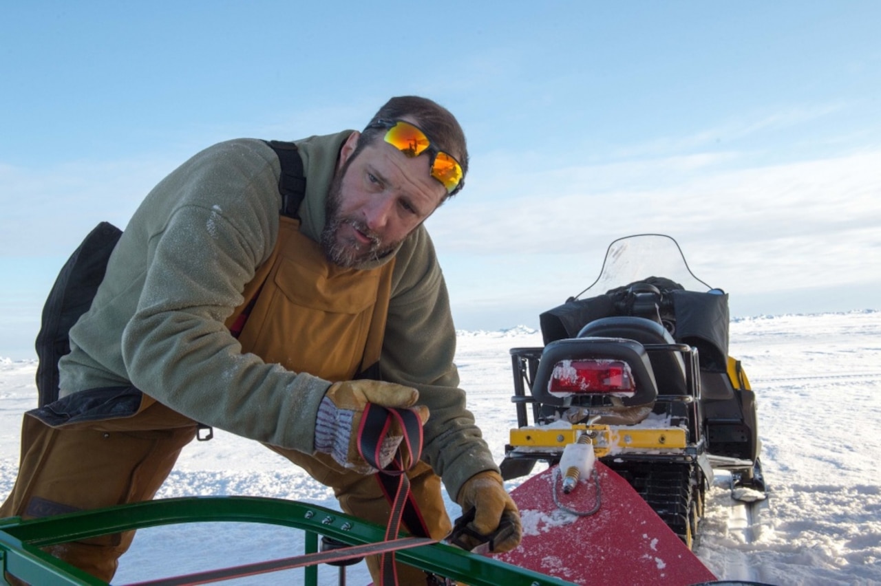 A research professor with the University of Alaska Fairbanks, prepares supplies for transport to Ice Camp Skate during the Navy’s Ice Exercise 2018 in the Arctic Circle.