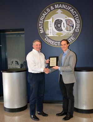 Dr. Richard Vaia (left), technical director, in the Materials and Manufacturing Directorate, was one of six people selected to receive the NextFlex Fellow award. Vaia is congratulated by Dr. Benjamin Leever, senior materials engineer and Government Chief Technology Officer of NextFlex. (U.S. Air Force photo/Karen Schlesinger)