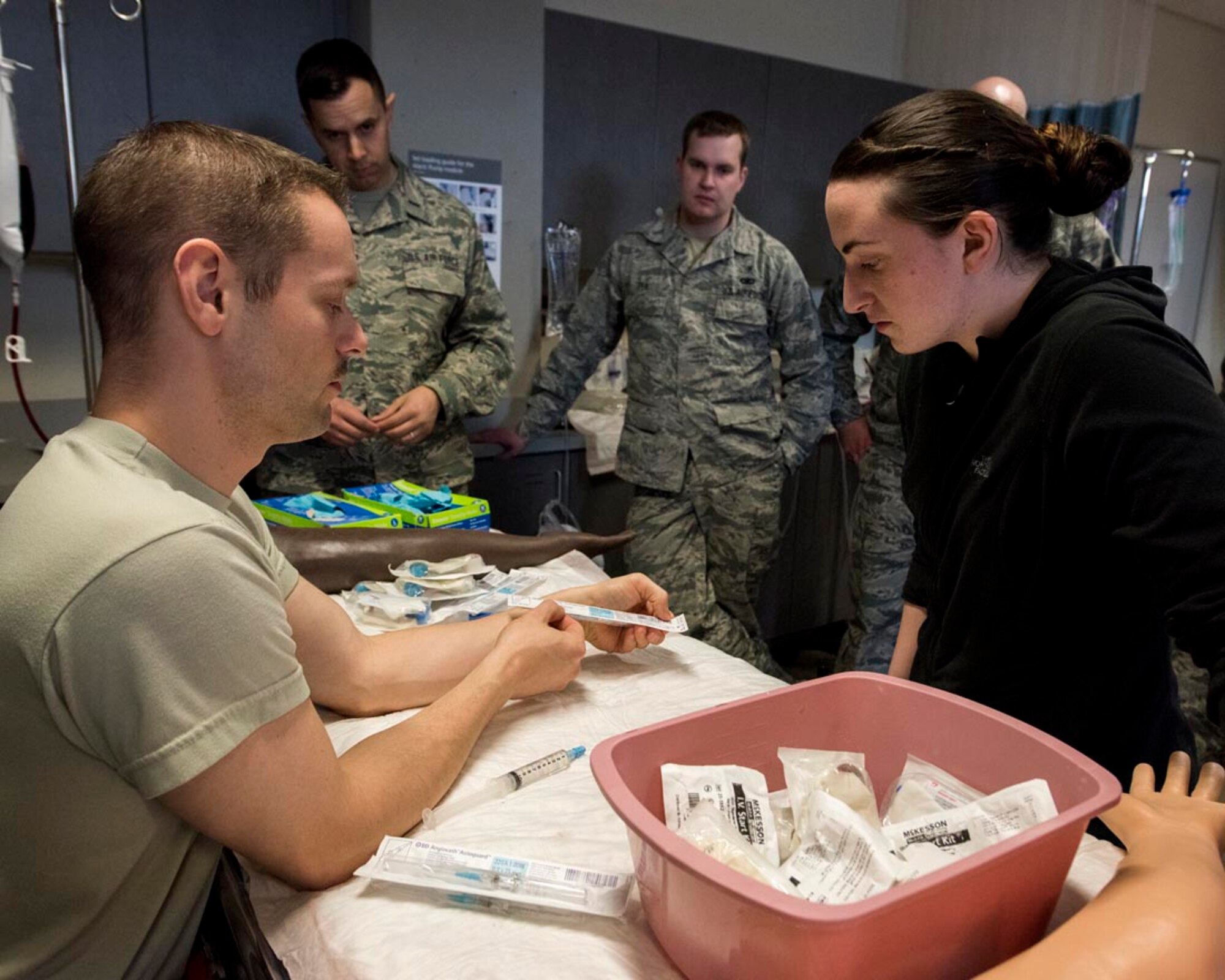 Capt. Neal Alexander, maternal child flight manager at the 92nd Medical Group, shows Airman 1st Class Jessica Schiller, an aerospace medical service apprentice at the 141st Medical Group, where to check for expiration dates on medical supplies during IV and laboratory draw training March 4, 2018 at the simulation lab at the Washington State University College of Nursing Riverpoint Campus in Spokane, Wash. More than 45 nurses, medics and medical providers from the 141st MDG as well as seven medical personnel assigned to the 92nd MDG teamed up for the combined training during March’s unit training assembly. (U.S. Air National Guard photo by Staff Sgt. Rose M. Lust)