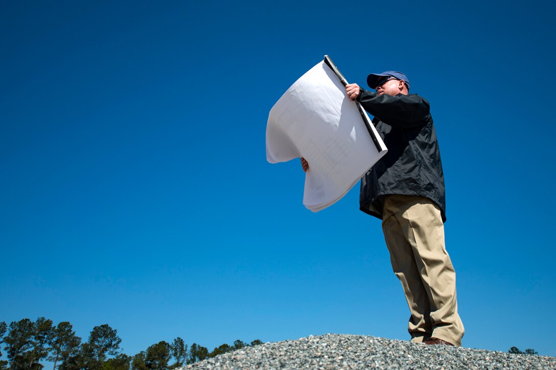 Joseph Vaughn, 23d Civil Engineer Squadron civil engineer, looks at his plan for the new rescue complex, March, 8, 2018, at Moody Air Force Base, Ga. The base is improving the Guardian Angel’s capabilities by building them new facilities to group the rescue assets closer together, so as to help better prepare for the future of their mission of saving lives. (U.S. Air Force photo by Airman 1st Class Erick Requadt)
