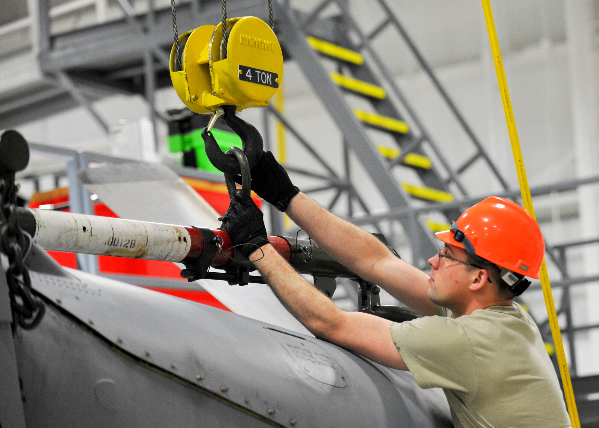 Senior Airman William Wright, an aerospace propulsion technician with the 910th Aircraft Maintenance Squadron here, unhooks a hoist from a C-130H Hercules engine.