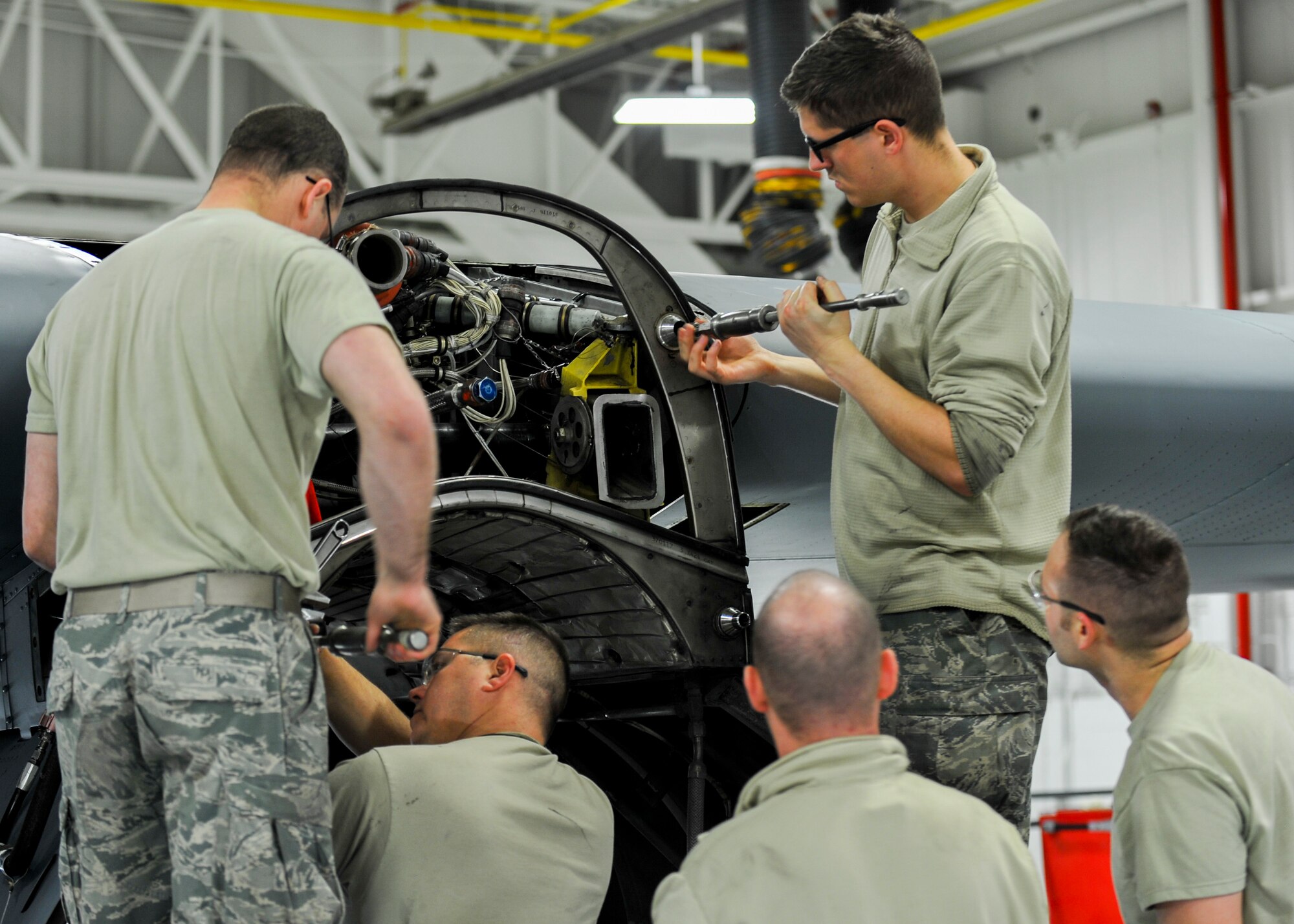 Senior Airman William Wright, Tech. Sgt. Steven Lew, Tech. Sgt. Jeff Burgess, Master Sgt. James Johnson and Senior Airman Daniel Phillis, aerospace propulsion technicians with the 910th Aircraft Maintenance Squadron here, work to remove and clean guide cones from a C-130H Hercules aircraft engine mounting point, March 7, 2018.
