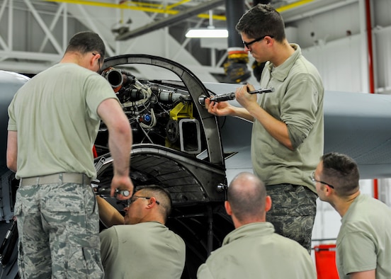 Senior Airman William Wright, Tech. Sgt. Steven Lew, Tech. Sgt. Jeff Burgess, Master Sgt. James Johnson and Senior Airman Daniel Phillis, aerospace propulsion technicians with the 910th Aircraft Maintenance Squadron here, work to remove and clean guide cones from a C-130H Hercules aircraft engine mounting point, March 7, 2018.