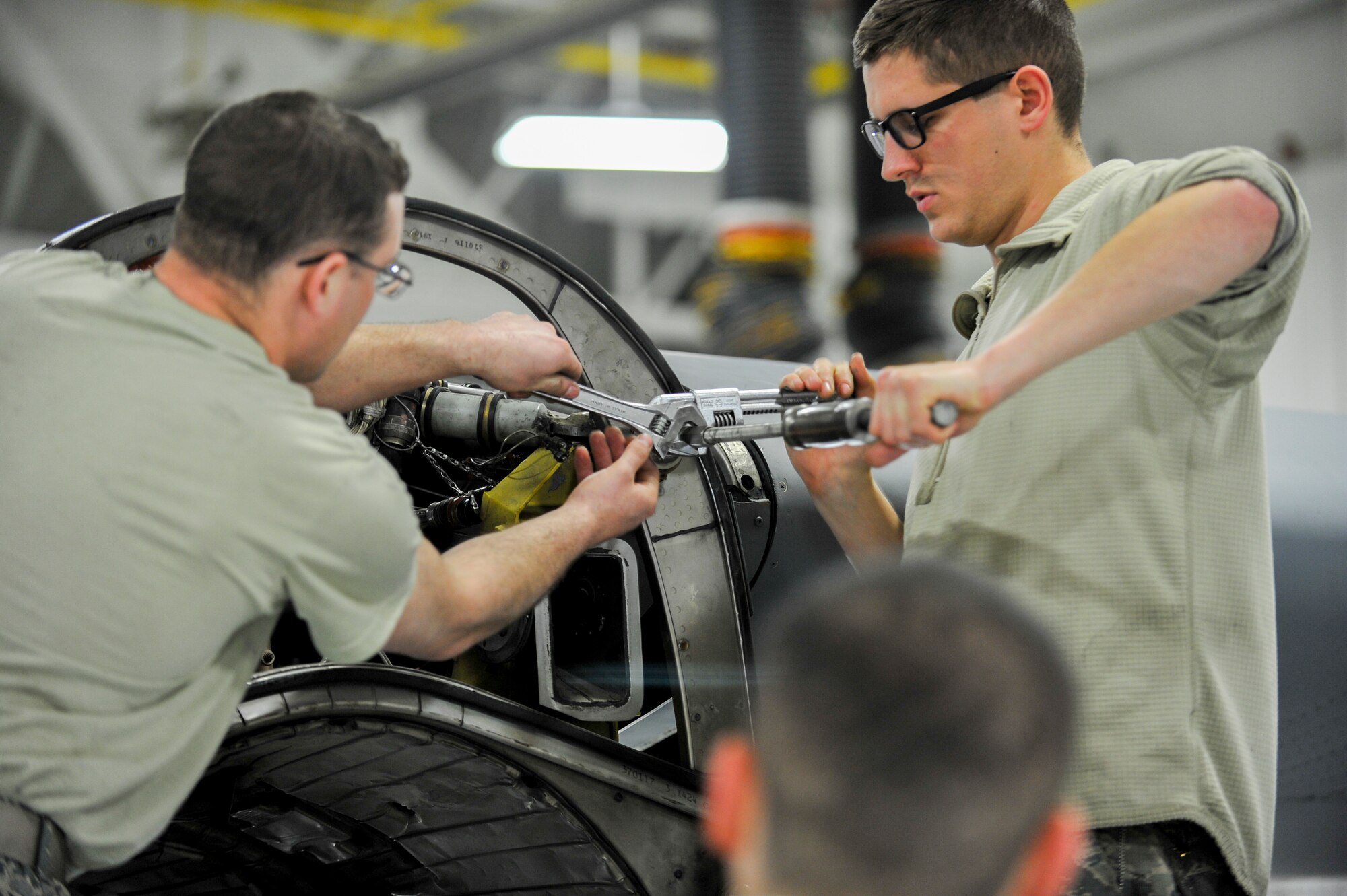Senior Airman William Wright and Senior Airman Daniel Phillis, both aerospace propulsion technicians with the 910th Aircraft Maintenance Squadron here, remove a guide cone from a C-130H Hercules aircraft engine mounting point, March 7, 2018.