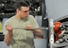Senior Airman William Wright, an aerospace propulsion helper from the 910th Aircraft Maintenance Squadron here, uses a specialized tool to remove a guide cone from a C-130H Hercules aircraft engine mounting point, March 7, 2018.