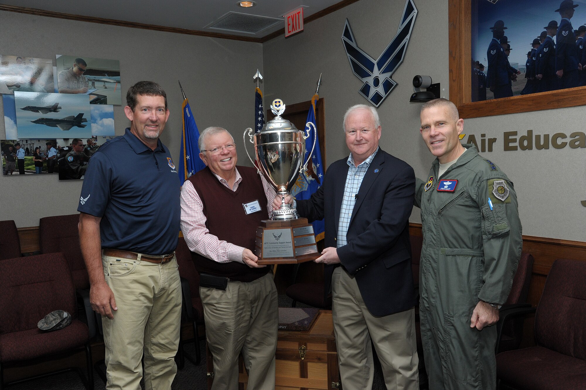 U.S. Air Force Lt. Gen. Steve Kwast, commander of Air Education and Training Command, (at right) and Dr. Joe Leverett, Altus Trophy committee chairman announced Biloxi, Mississippi, as the 2017 Altus Trophy winner and presented the award to John Boothby and Lenny Sawyer of the Biloxi Bay Area Chamber of Commerce at Joint Base San Antonio-Randolph, Texas, March 8, 2018. The Altus Trophy is given to the community judged to have shown outstanding support to an AETC base. (U.S. Air Force photo by Joel Martinez)