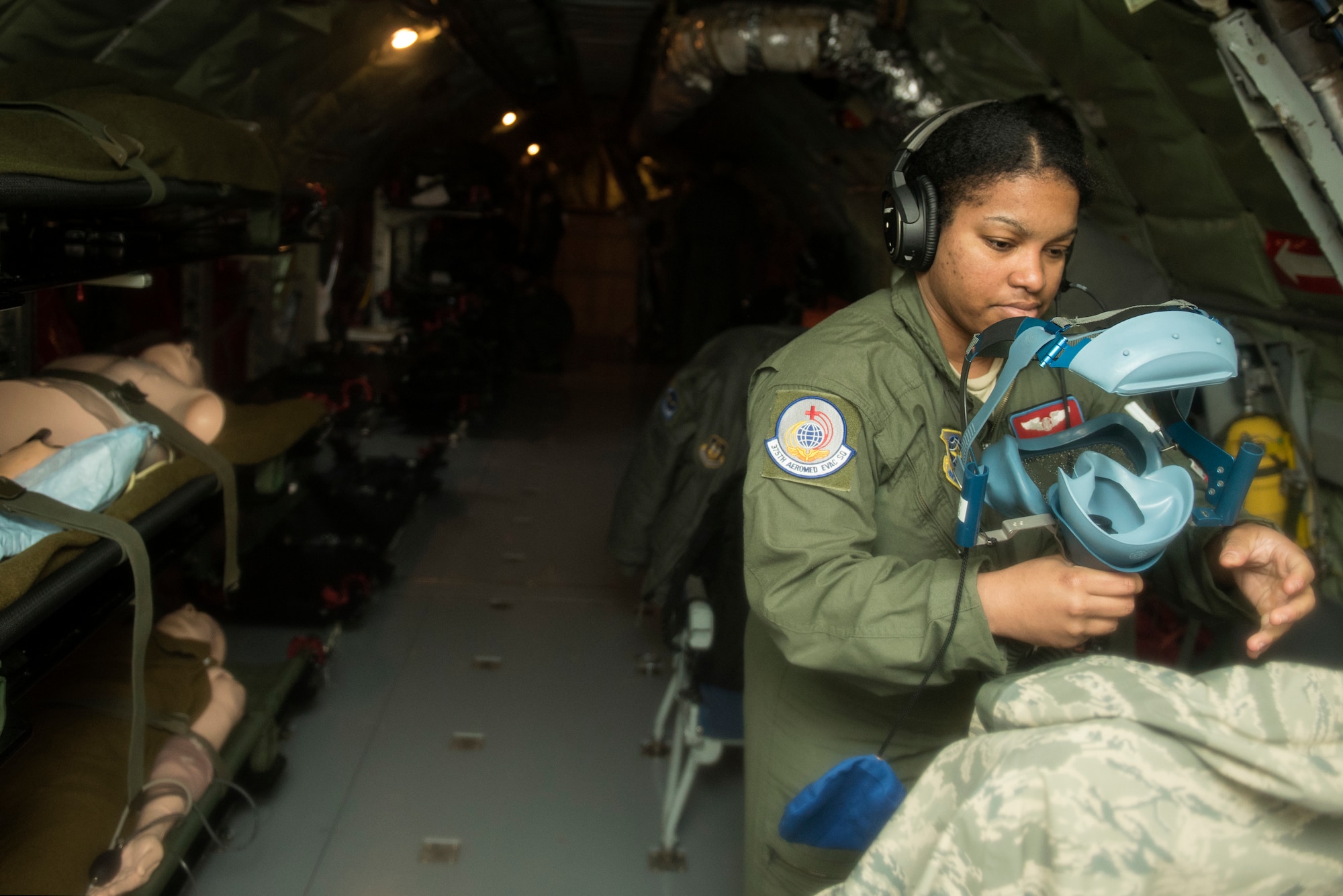 Staff Sgt. Raymeisha Childs, 375th Aeromedical Evacuation Squadron aeromedical technician, checks an oxygen mask during an aeromedical evacuation training at Fairchild Air Force Base, Washington, March 1, 2018. It is essential for all medical equipment to be functioning properly to provide critical care for each patient during transport. (U.S. Air Force photo/Airman 1st Class Whitney Laine)