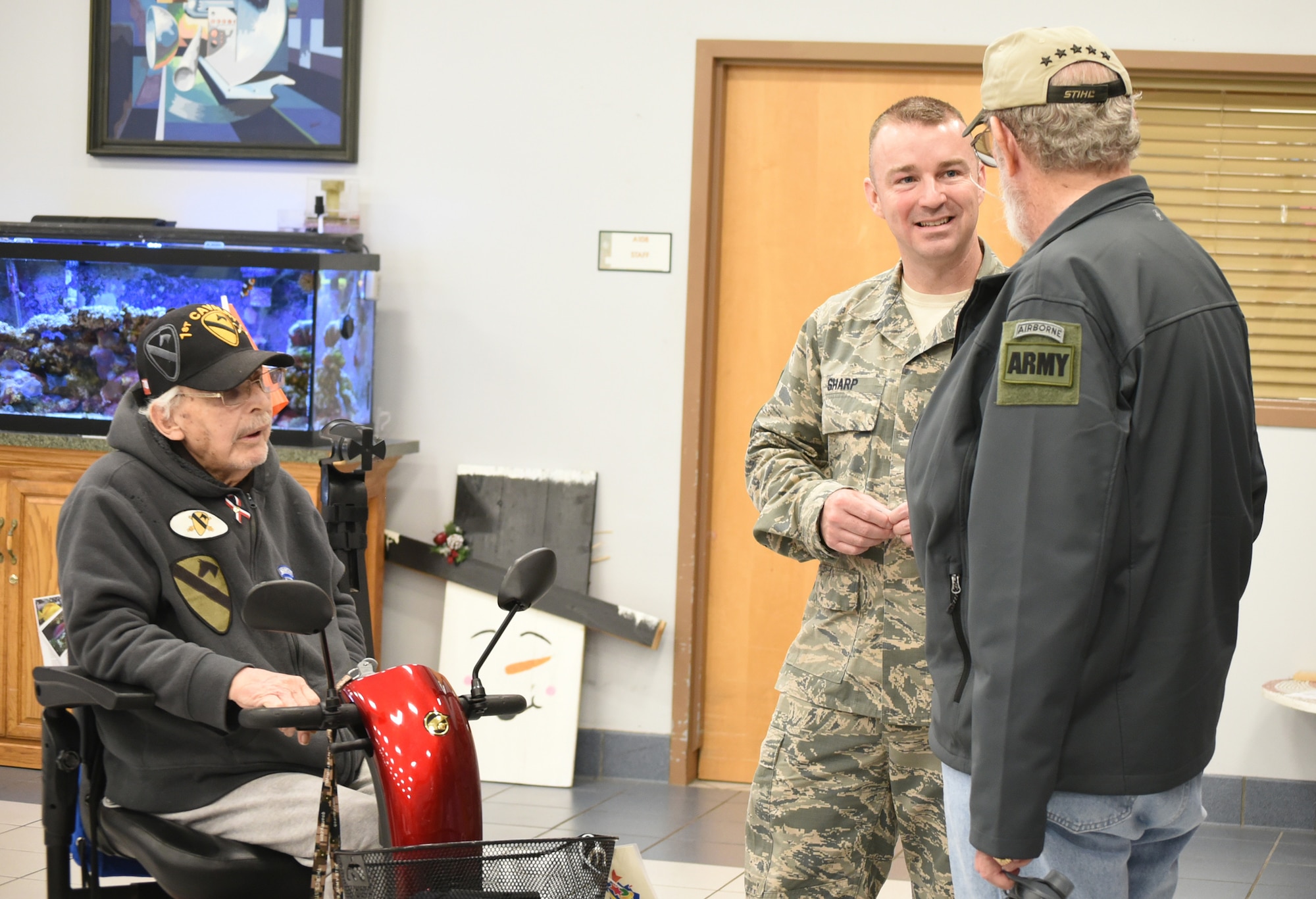 Chief Master Sgt. Gary Sharp, Air Force Sustainment Center command chief, visits with veterans Norman Tripp, left, and Patrick Farnon Feb. 28, 2018, at the Norman Veterans Center in Norman, Oklahoma.