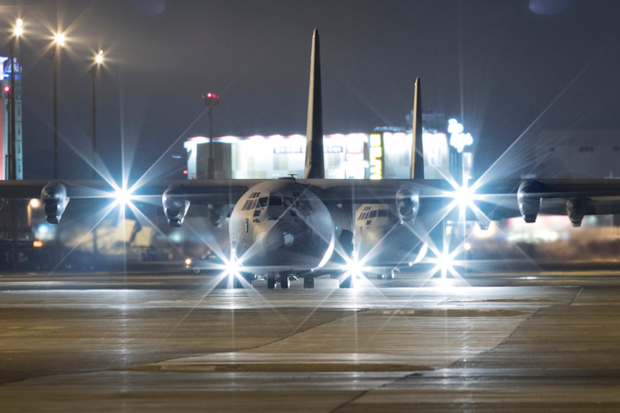 Two C-130J Super Hercules taxi on the runway