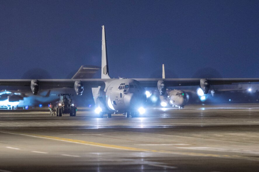 Airmen with the 374th Logistics Readiness Squadron combat mobility flight offload cargo from a C-130J Super Hercules