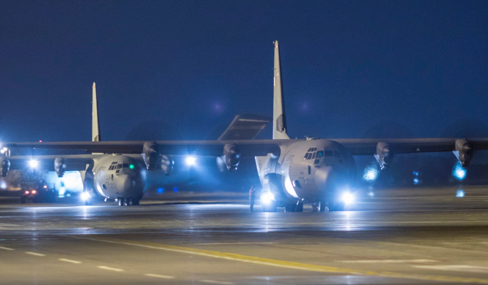 Airmen with the 374th Logistics Readiness Squadron combat mobility flight offload cargo from a C-130J Super Hercules