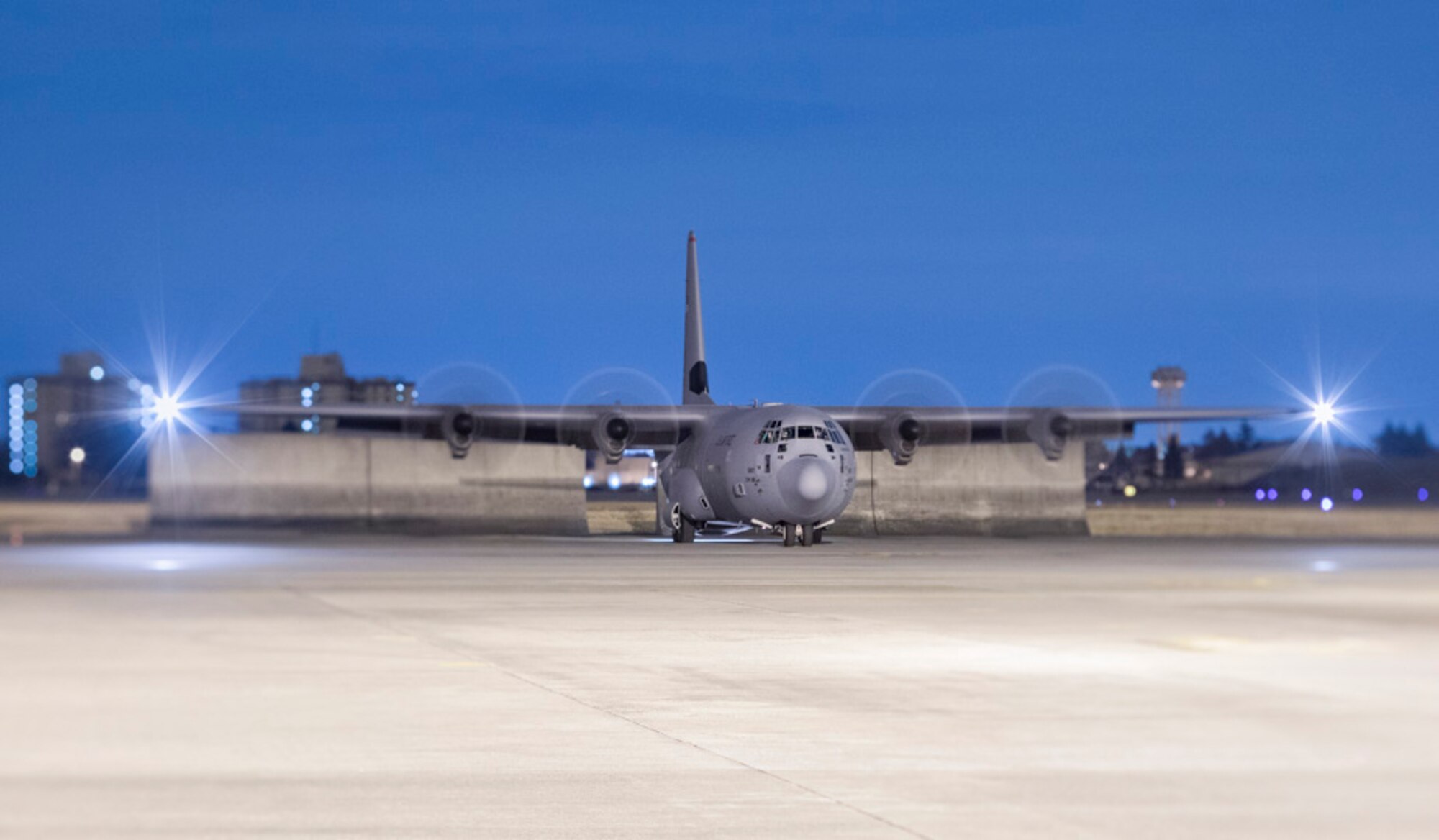 A C-130J Super Hercules waits to taxi down the flightline after returning a night training mission