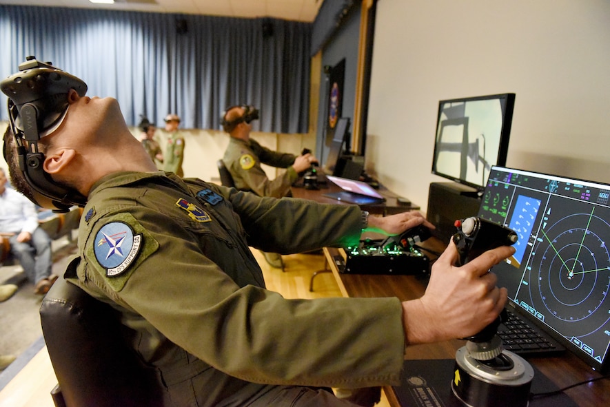 U.S. Air Force Lt. Col. Jason Turner, 80th Operations Support commander, looks up during a maneuver in a mixed reality flight simulator at Sheppard Air Force Base, Texas, March 7, 2018. The software, demonstrated by Flight Safety International, could be used in the future to enhance the undergraduate pilot training syllabus in the 80th Flying Training Wing. (U.S. Air Force photo by John Ingle)