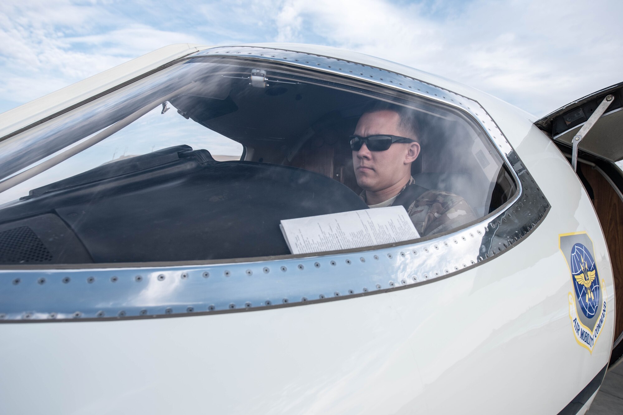 U.S. Air Force 1st Lt. Riley Snowden, a pilot assigned to the 746th Expeditionary Airlift Squadron, performs pre-flight tasks in the flight deck of a C-21 at Al Udeid Air Base, Qatar, Feb. 7, 2018. The C-21 is primarily used to deliver members of leadership most commonly consisting of general officer or their civilian counterparts, quickly and efficiently to bases across the U.S. Central Command’s area of responsibility. (U.S. Air National Guard photo by Master Sgt. Phil Speck)