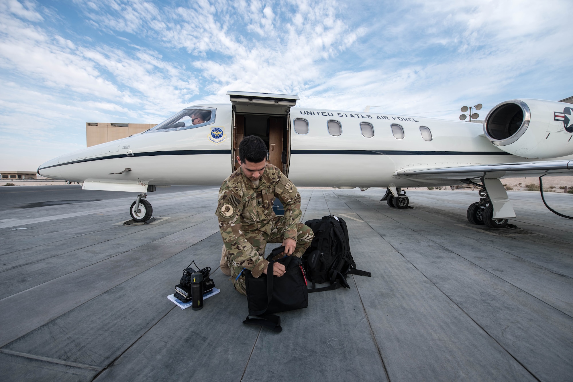 U.S. Air Force 1st Lt. Riley Snowden, a pilot assigned to the 746th Expeditionary Airlift Squadron, performs pre-flight tasks in the flight deck of a C-21 at Al Udeid Air Base, Qatar, Feb. 7, 2018. The C-21 is primarily used to deliver members of leadership most commonly consisting of general officer or their civilian counterparts, quickly and efficiently to bases across the U.S. Central Command’s area of responsibility. (U.S. Air National Guard photo by Master Sgt. Phil Speck)