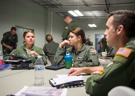 U.S. Air Force Maj. Dana Novinskie, 109th Airlift Squadron, briefs members of her team prior to a C-130 Hercules airdrop mission in Yuma, Ariz., Feb. 26, 2018.