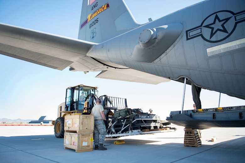 Small Air Terminal personnel from the 133rd Logistics Readiness Squadron load a Containerized Delivery System (CDS) into a C-130 Hercules for an airdrop mission in Yuma, Ariz., Feb. 26, 2018.