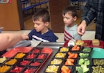 Two students proceed through the lunch line at Sayre School District in Pennsyvania. The school district gets its fresh fruits and vegetables through a partnership between DLA Troop Support and the USDA School Lunch program.
