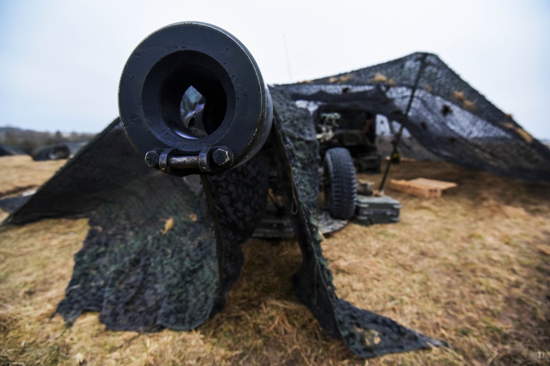 Soldiers prepare a howitzer before conducting a live-fire exercise.