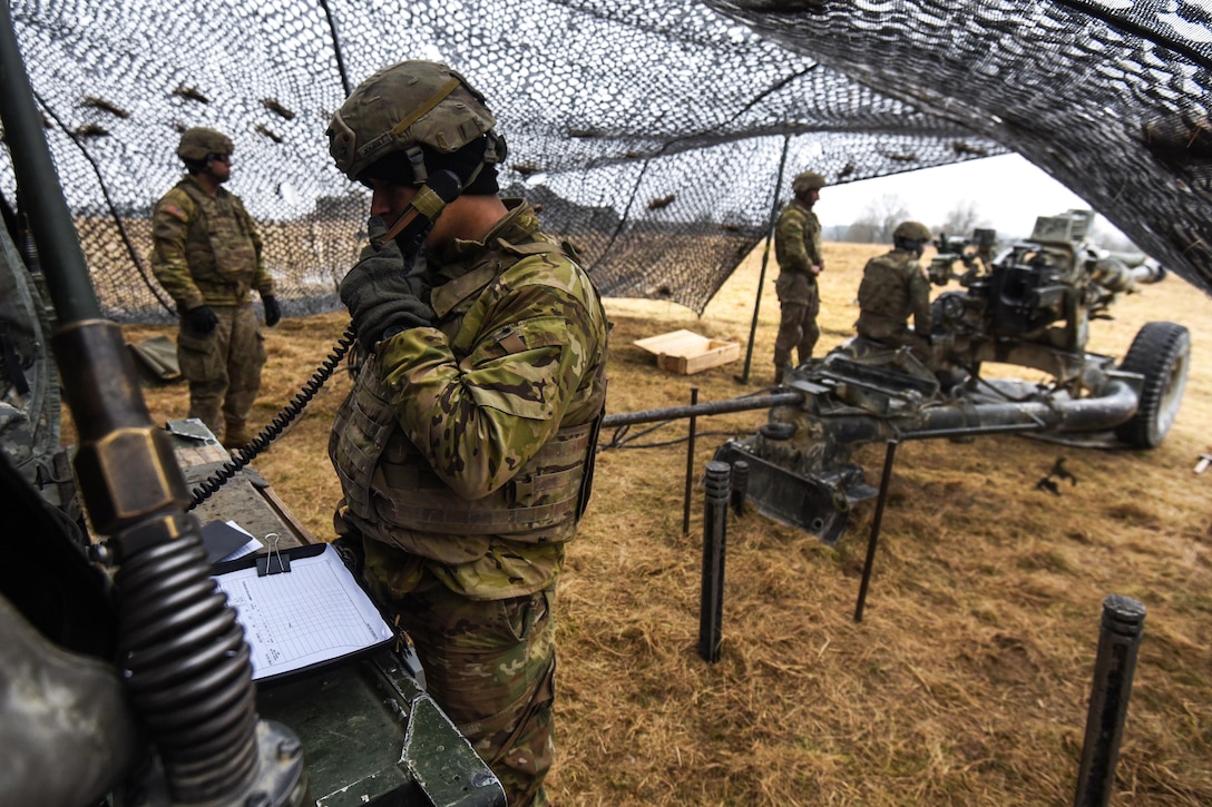 A soldier radios his headquarters leadership for fire coordinates.