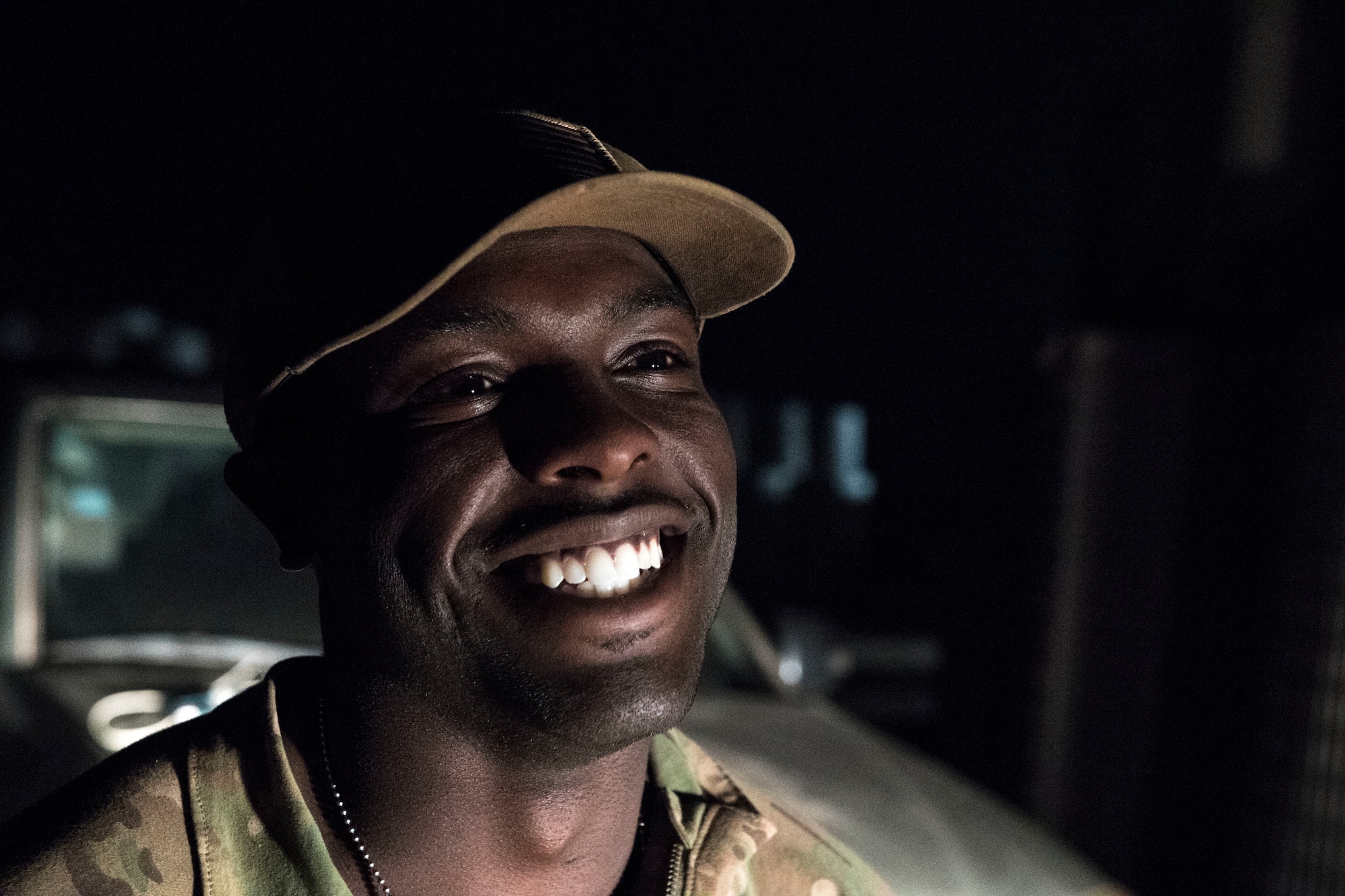 U.S. Air Force Staff Sgt. Mackenzie Isidor, 822nd Expeditionary Base Defense Squadron fire team leader, laughs during a night-shift conversation with one of cowrkers, Feb. 26, 2018, at Nigerien Air Base 201, in Agadez, Niger. Isidor inspires Airmen to consistently put in a conscientious effort to seek opportunities to succeed in the military. (U.S. Air Force photo by Tech. Sgt. Nick Wilson)
