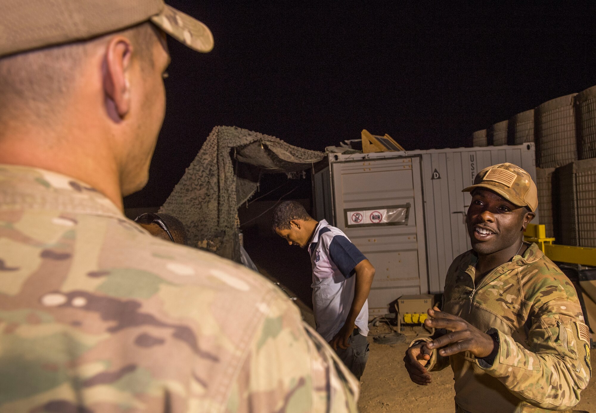 U.S. Air Force Staff Sgt. Mackenzie Isidor, 822nd Expeditionary Base Defense Squadron fire team leader, talks with Senior Airman Austen Gann, 822nd EBDS fire team member, during a night shift at Nigerien Air Base 201, in Agadez, Niger, Feb. 26, 2018. Isidor and Gann are deployed to Nigerien Air Base 201 from Moody Air Force Base, Georgia. (U.S. Air Force photo by Tech. Sgt. Nick Wilson)