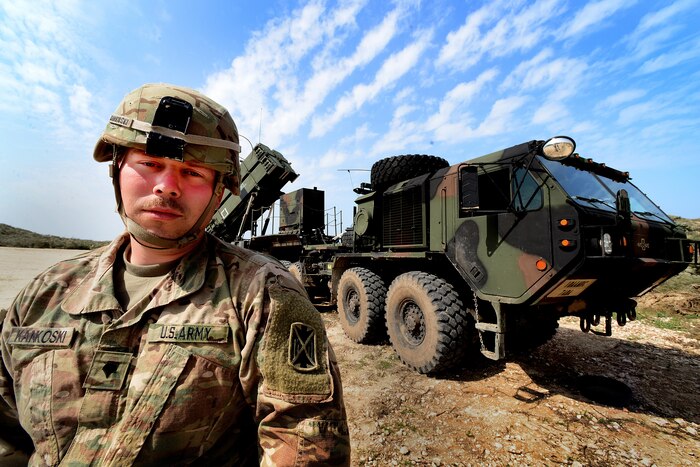 A U.S. soldier stands in front of a missile battery in Israel.