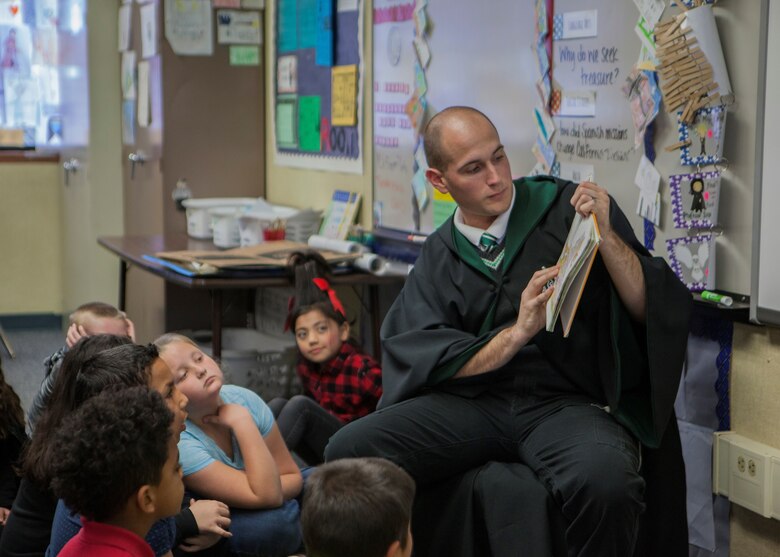 Cpl. Ryan Britton, Radio Technician with Headquarters and Service Battalion, 1st Tank Battalion, reads a book to students in support of Read Across America at Friendly Hills Elementary School in Joshua Tree, Calif., on March 2, 2018.  Read Across America is an annual reading motivation and awareness program that calls for every child in every community to celebrate reading. (U.S. Marine Corps Photo by Cpl. Francisco J. Britoramirez)