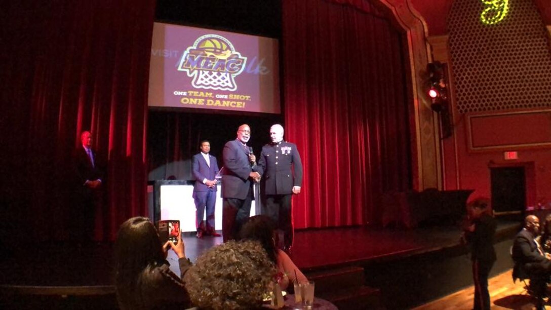Dr. Dennis E. Thomas welcomes Major General Paul Kennedy to the stage during the Mid-Eastern Athletic Conference (MEAC) mayor's reception, March 6, 2018. The Marine Corps and MEAC have had a seven-year partnership thus far, and continues to generate long-lasting and meaningful relationships between those who attend and the Marines. Thomas is the commissioner of MEAC. Kennedy is the commanding general of Marine Corps Recruiting Command.