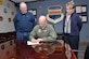 Timothy Slobodnik (L), 55th Civil Engineer Squadron and AFGE Local Chapter 1486 president and Shay Caris (R), 55th FSS Civilian Personnel Flight Labor Relations officer watch Col. Michael Manion, 55th Wing commander, sign a new collective bargaining agreement on March 7 at 55th Wing headquarters on Offutt Air Force Base, Nebraska.