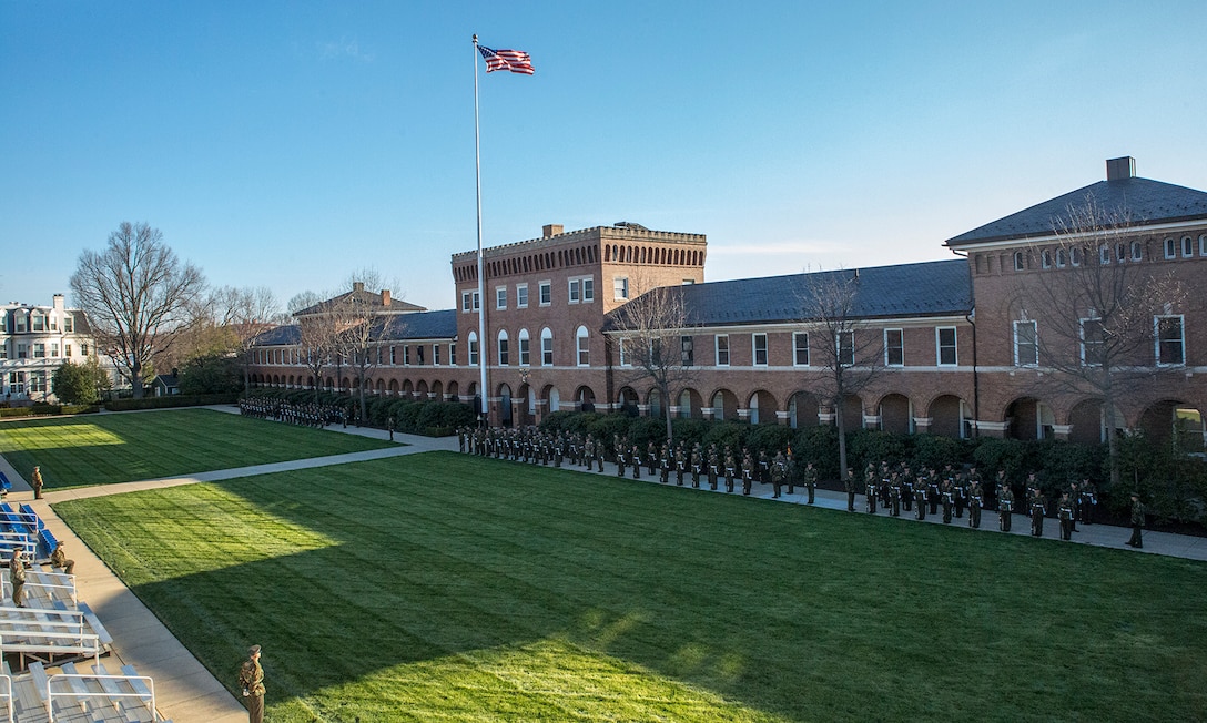 Gunnery Sgt. Aaron Calderon, drill master, Marine Barracks Washington, critiques the marching elements of MBW to hone and sharpen their drill sequences as they conduct Phase I and Phase II drill practice on the parade deck at Marine Barracks Washington D.C., Mar. 9, 2018. The Marines execute these iterations three days a week in preparation for the upcoming 2018 Parade Season. (Official Marine Corps photo by Cpl. Robert Knapp/Released)