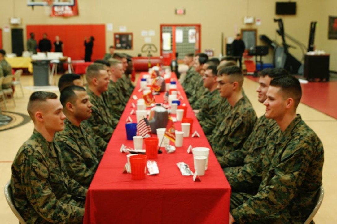 Marines and sailors with Headquarters and Service Battalion, U.S. Marine Corps Forces Command, participate in the unit mess night at Hopkins Hall Gymnasium at Camp Allen, Norfolk, Va., March 8. Marines and sailors throughout the command gathered to take part in this time-honored tradition, enhancing camaraderie esprit de corps for senior service members and junior service members alike. (Courtesy Photo/Released)