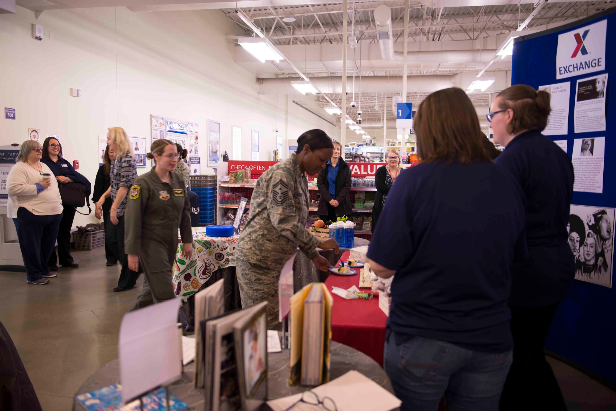 Members of the base community grab a piece of cake at the cake cutting and recognition ceremony during International Women's Day March 8, 2018, at Mountain Home Air Force Base, Idaho. Airmen from different backgrounds were given the opportunity to express their thoughts on their female mentors, inspirations and influences that made them who they are today. (U.S. Air Force photo by Senior Airman Lauren-Taylor Levin)