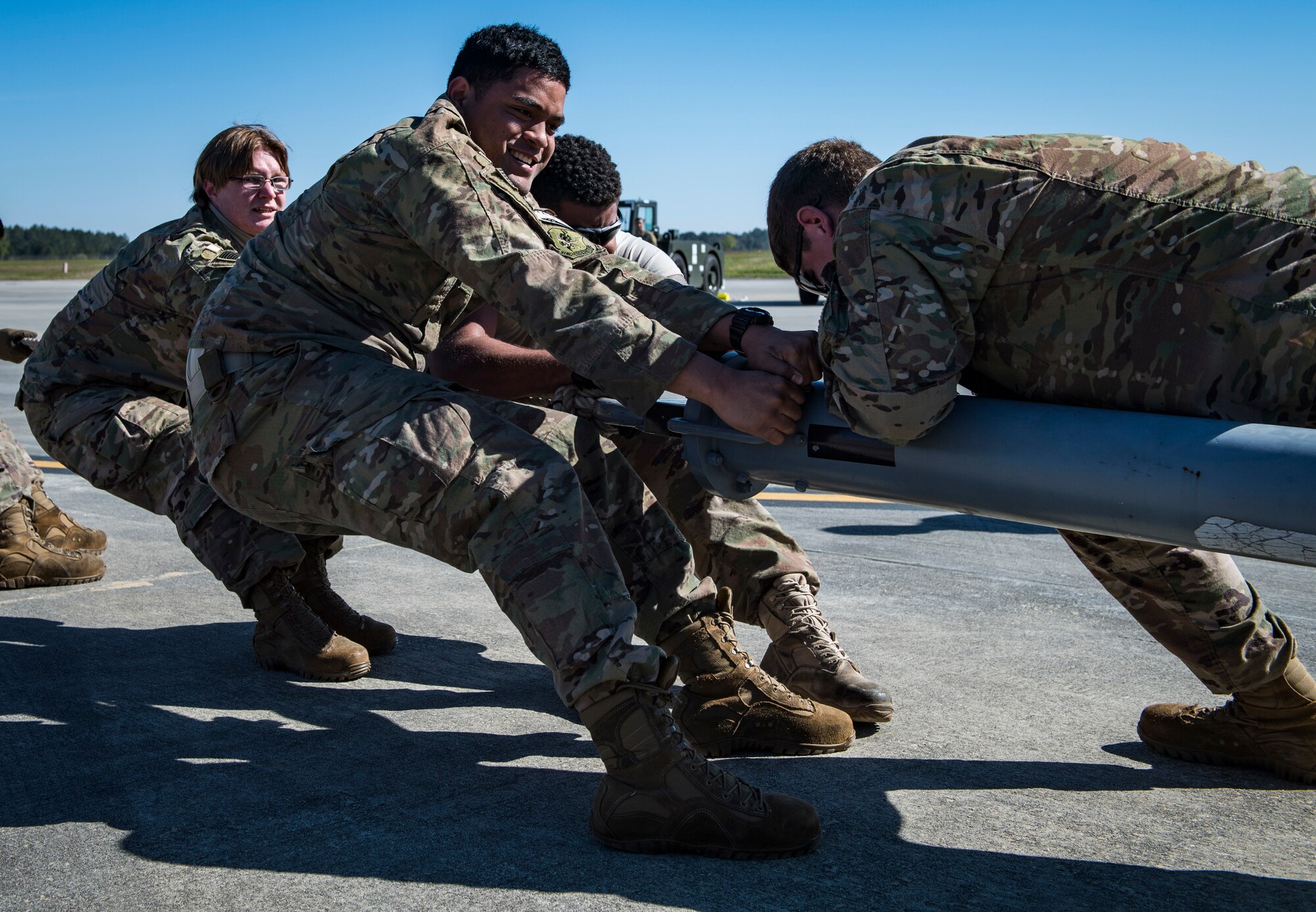 Airmen from the 41st Helicopter Maintenance Unit pull an HC-130J Combat King II during an aircraft pull challenge, March 9, 2018, at Moody Air Force Base, Ga. The challenge was part of a Comprehensive Airman Fitness super sports day event where the 41st HMU and 71st Aircraft Maintenance Unit faced off for bragging rights. (U.S. Air Force Photo by Senior Airman Janiqua P. Robinson)