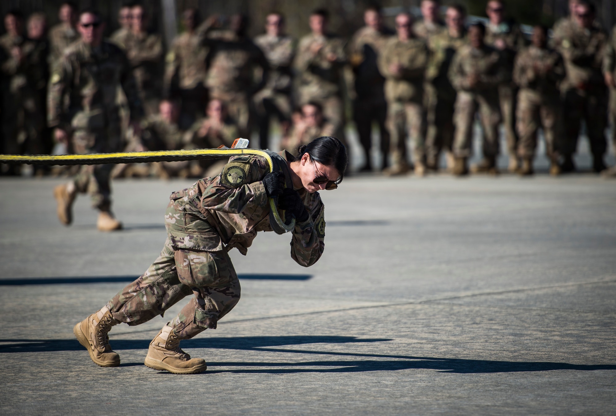 An Airman from the 71st Aircraft Maintenance Unit pulls an HH-60G Pave Hawk helicopter during an aircraft pull challenge, March 9, 2018, at Moody Air Force Base, Ga. The challenge was part of a Comprehensive Airman Fitness super sports day event where the 71st AMU and 41st Helicopter Maintenance Unit faced off for bragging rights. (U.S. Air Force Photo by Senior Airman Janiqua P. Robinson)