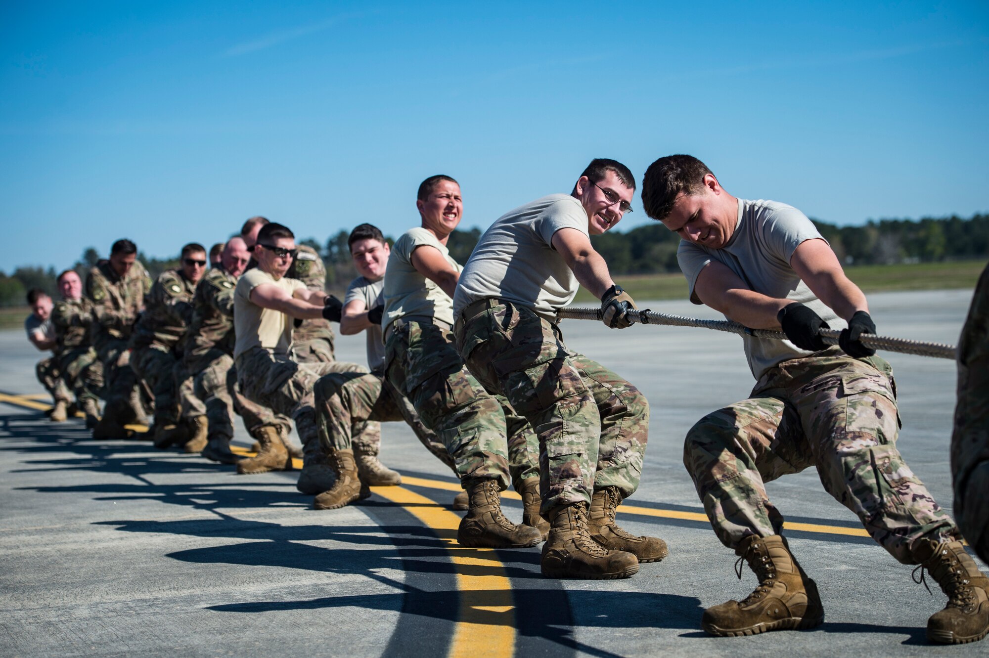 Airmen from the 41st Helicopter Maintenance Unit pull an HC-130J Combat King II during an aircraft pull challenge, March 9, 2018, at Moody Air Force Base, Ga. The challenge was part of a Comprehensive Airman Fitness super sports day event where the 41st HMU and 71st Aircraft Maintenance Unit faced off for bragging rights. (U.S. Air Force Photo by Senior Airman Janiqua P. Robinson)