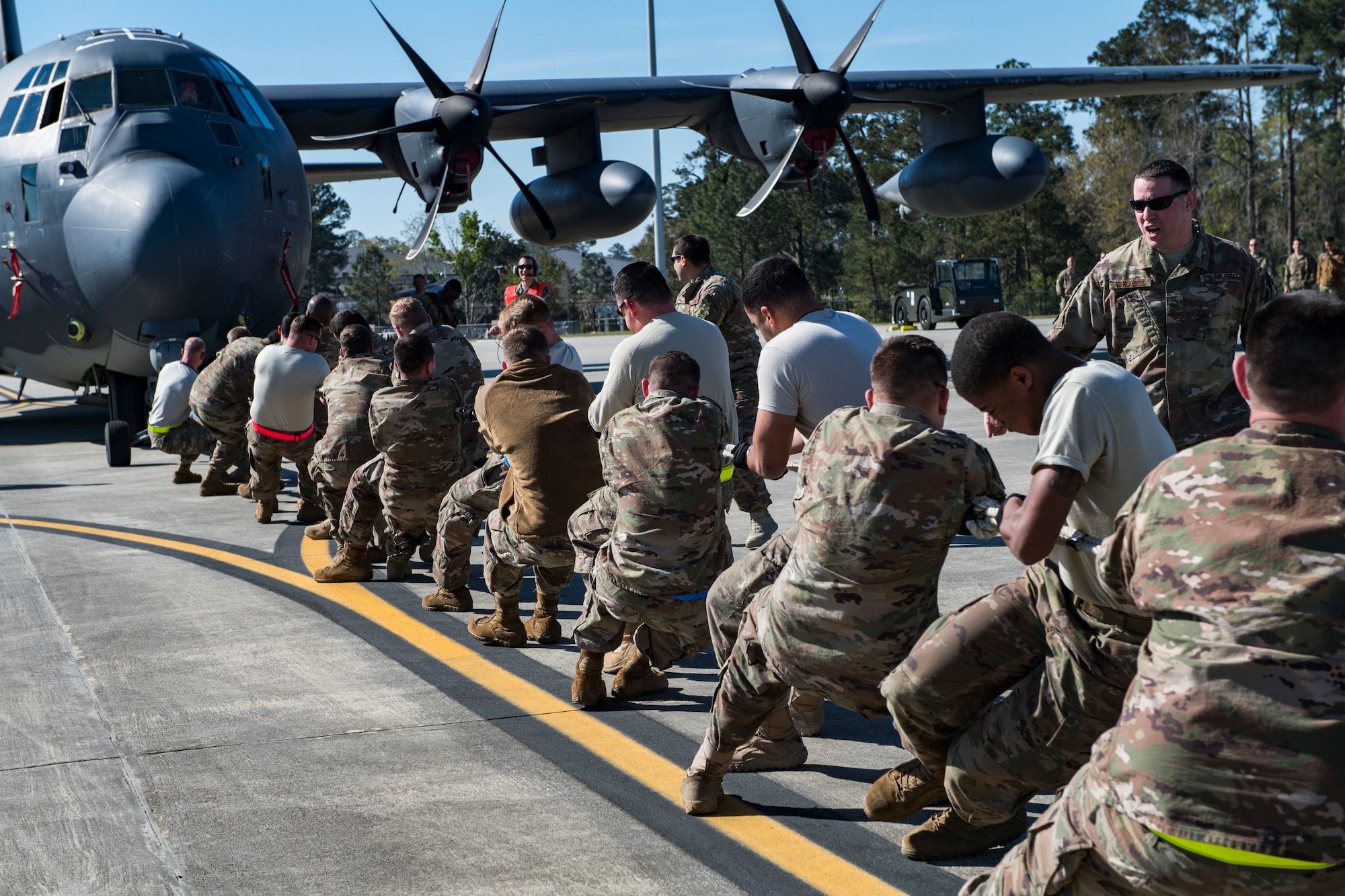 Airmen from the 71st Aircraft Maintenance Unit pull an HC-130J Combat King II during an aircraft pull challenge, March 9, 2018, at Moody Air Force Base, Ga. The challenge was part of a Comprehensive Airman Fitness super sports day event where the 71st AMU and 41st Helicopter Maintenance Unit faced off for bragging rights. (U.S. Air Force Photo by Senior Airman Janiqua P. Robinson)