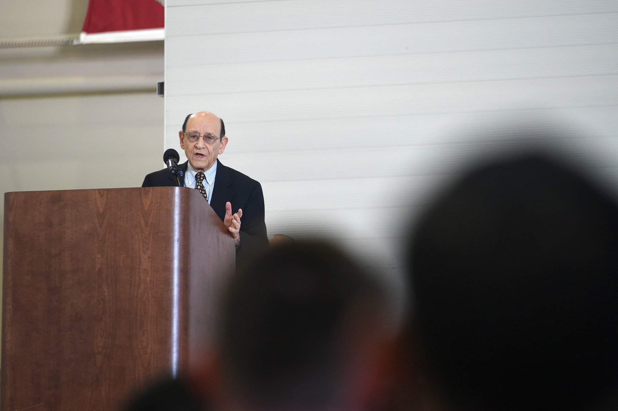 Mr. Abraham Karem, president of Karem Aircraft Incorporated, speaks during the MQ-1 Predator retirement ceremony March 9, 2018, at Creech Air Force Base, Nev. Karem is considered the “father” of the MQ-1 for having built an earlier model of what later evolved into the MQ-1 in his home garage. (U.S. Air Force photo by Senior Airman James Thompson)