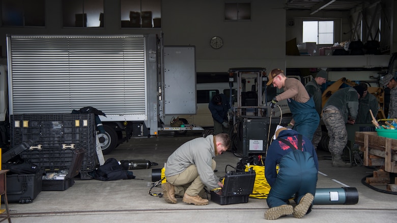 U.S. Navy and U.S. Air Force personnel prepare equipment at Lake Ogawara, Tohoku Town, Japan, March 10, 2018.