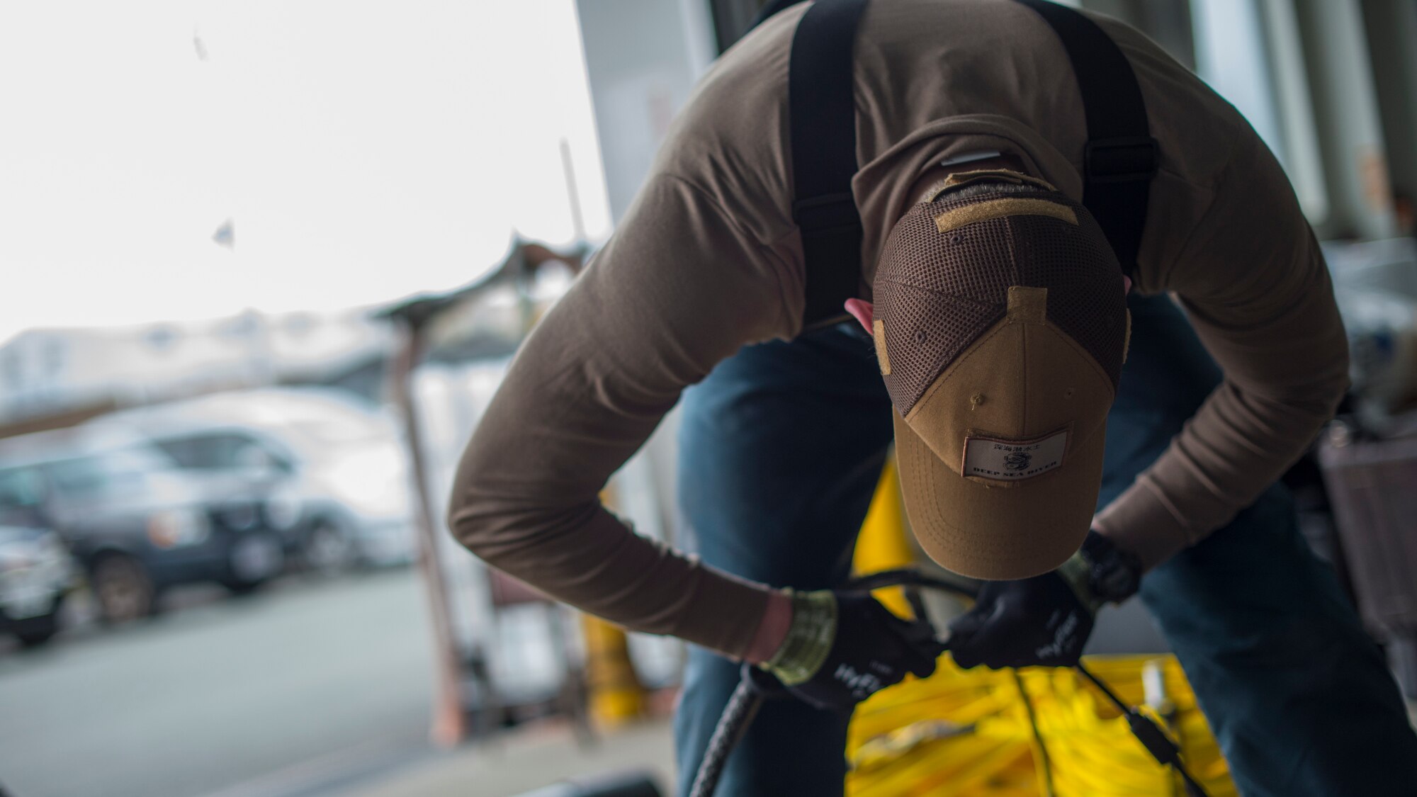 U.S. Navy Diver 2nd Class Mitchell Apgar, assigned to Commander, Fleet Activities Sasebo, prepares diving equipment prior to cleanup efforts at Lake Ogawara, Tohoku Town, Japan, March 10, 2018.