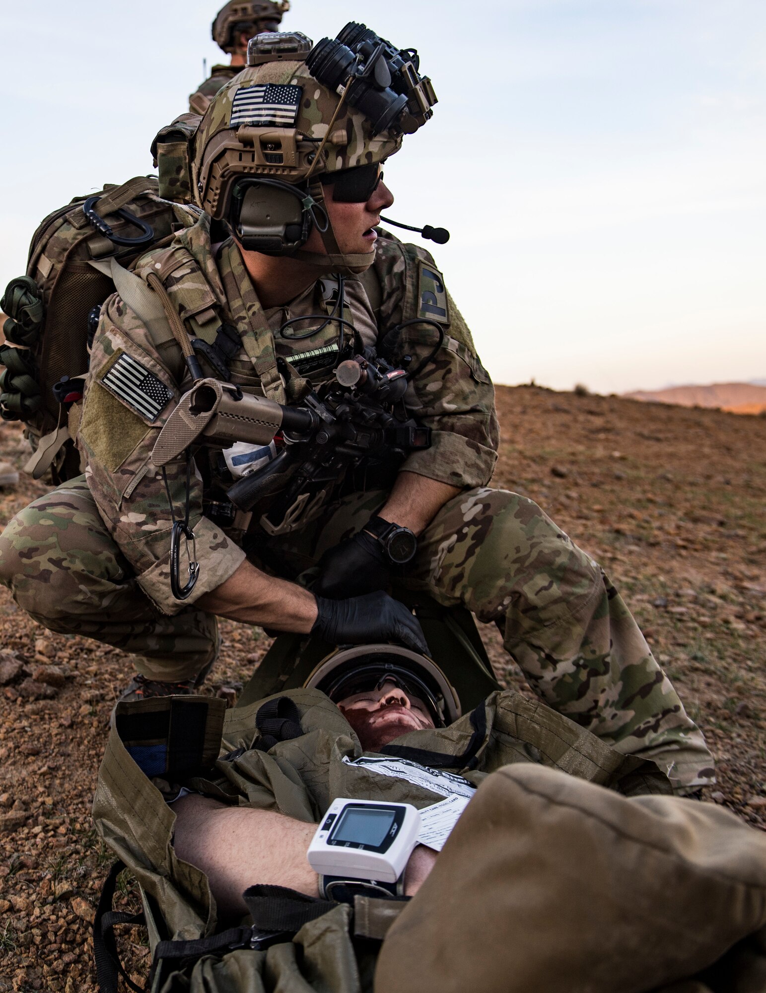 A U.S. Air Force pararescueman, assigned to the 83rd Expeditionary Rescue Squadron, prepares to move a simulated casualty during a personnel recovery exercise at an undisclosed location in Afghanistan, March 6, 2018. Army aircrews and Air Force Guardian Angel teams conducted the exercise to build teamwork and practice procedures as they provide joint personnel recovery capability, aiding in the delivery of decisive airpower for U.S. Central Command. (U.S. Air Force Photo by Tech. Sgt. Gregory Brook)