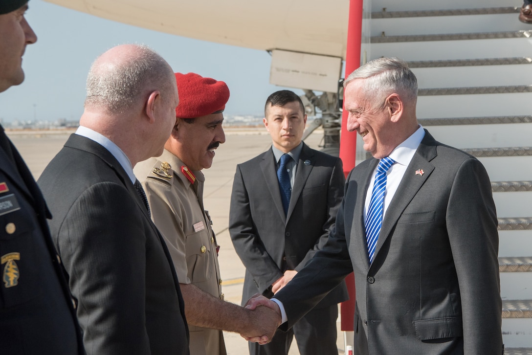 Defense Secretary James N. Mattis shakes hands with a person from the Omani defense ministry.