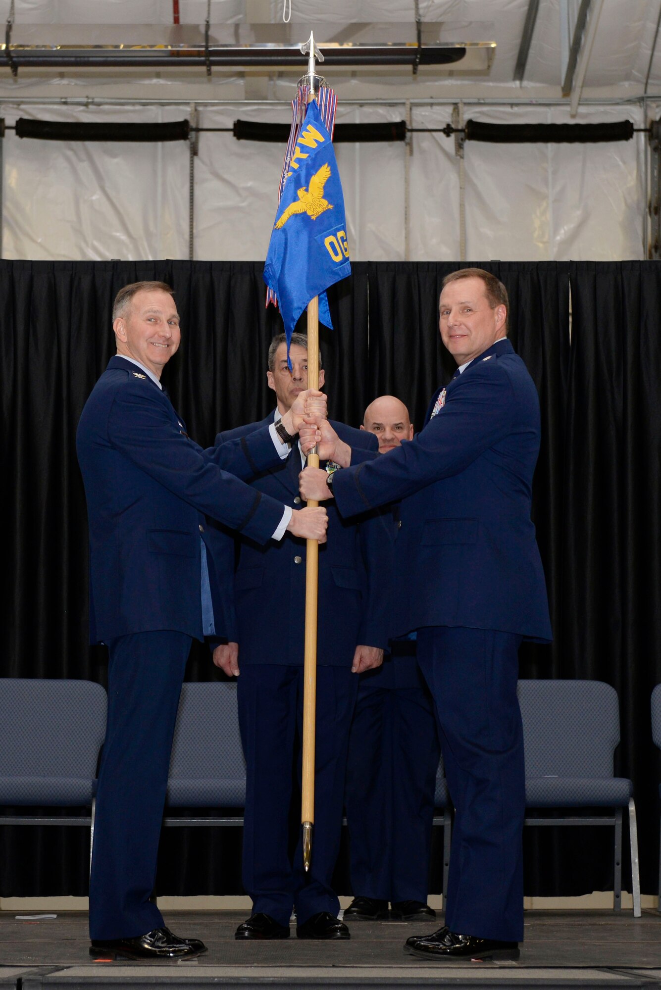 Lt. Col. Mark W. Ustaszewski (right) accepts the 157th Operations Group guidon from Col. James Ryan, commander 157th Air Refueling Wing during a change of command ceremony at Pease Air National Guard Base, N.H., March 10, 2018. The change of commmand cermony represents a formal transfer of authority and responsibility from an outgoing commander to the incoming commander.(N.H. Air National Guard photo by Senior Airman Taylor Queen)