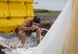 U.S. Navy Petty Officer 1st Class Andrew Morales, a Commander Task Force 72 information systems technician, slides through an obstacle as part of a regatta competition during the first Team Misawa Resilient Relationships and Appreciation Day, at Misawa Air Base, Japan, Aug. 18, 2017. The regatta, which is a boat racing competition, challenged personnel with working together to build their own boats, test its floatation and race in Lake Ogawara. The 35th Fighter Wing Chapel coordinated the event and tested teams’ capabilities to think critically and work together, exercising their physical and mental pillars of resiliency, which service members incorporate in their daily career tasks. (U.S. Air Force photo by Senior Airman Sadie Colbert)